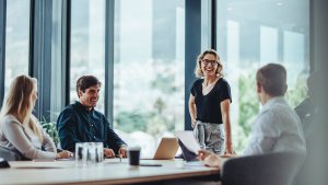 People in an office meeting being happy and working well