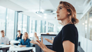 Business woman delivering a presentation at a conference