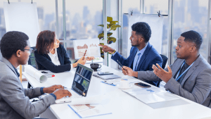 manager is showing annual report chart to her colleagues in the executive meeting