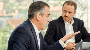 Two businessmen sitting at a table talking