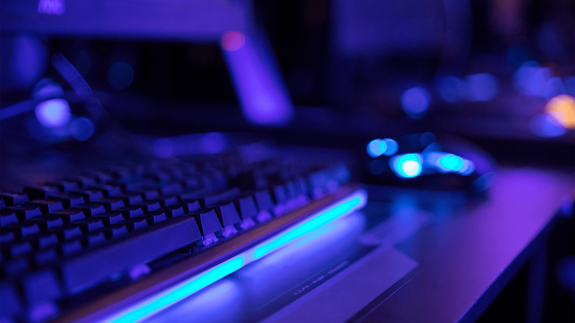 desktop keyboard and mouse blurred out in a blue colour