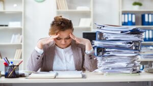 Businesswoman very busy with ongoing paperwork