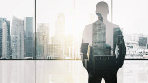 silhouette of business man over office background