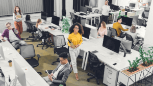 high angle view of multiracial young business people working with computers and documents in open space office