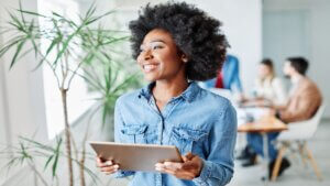 portrait of a smiling young businesswoman holding a tablet in the office