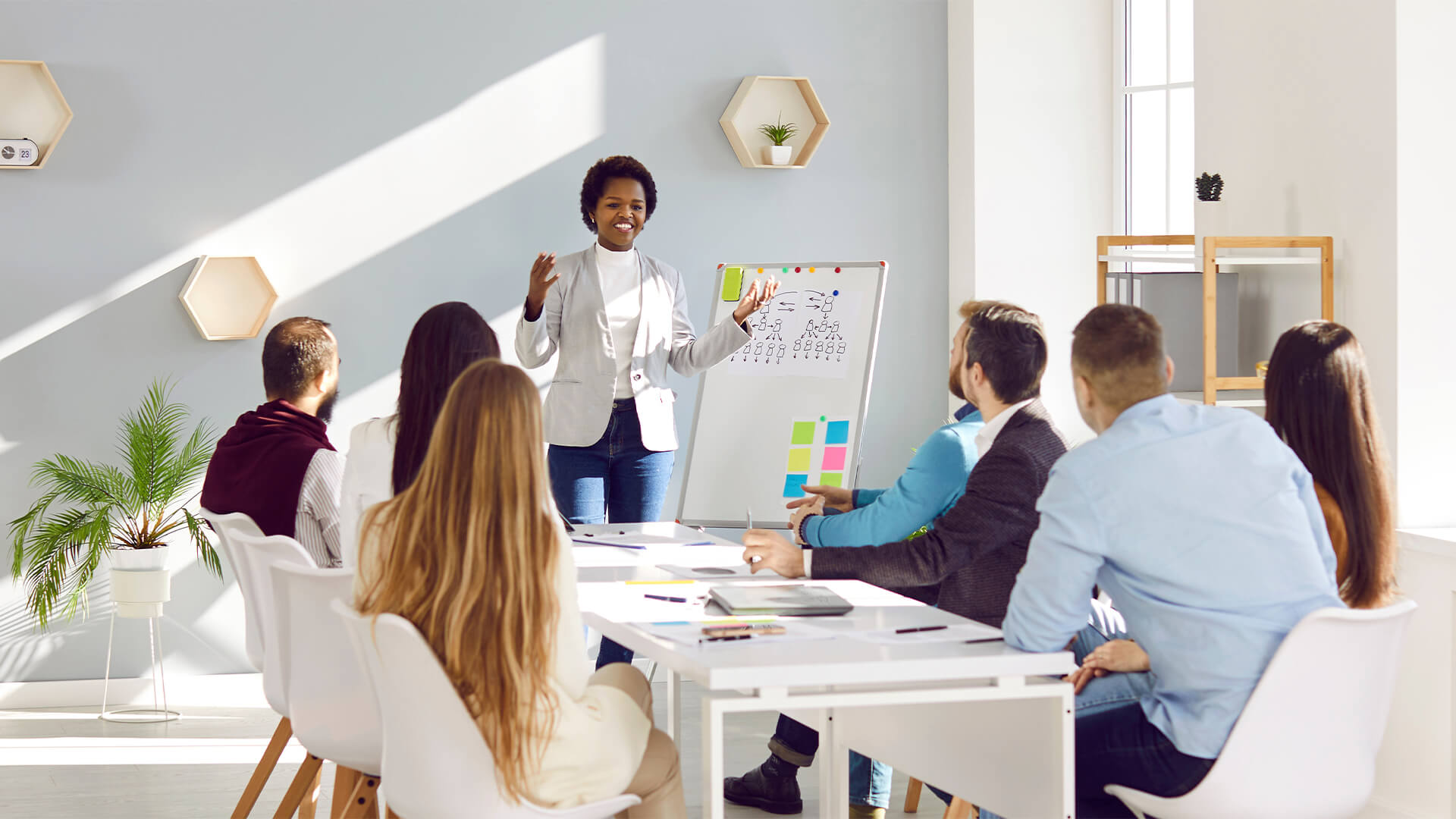 modern company or startup listening to African American woman presentation about business