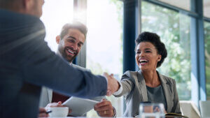 Meeting, partnership and business people shaking hands in the office for a deal, collaboration or onboarding