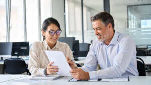 diverse professional colleagues discussing tax financial contract papers working in office at meeting