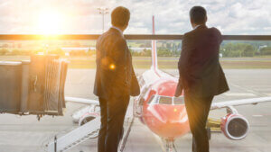 Mature businessmen standing while looking on the plane in airport