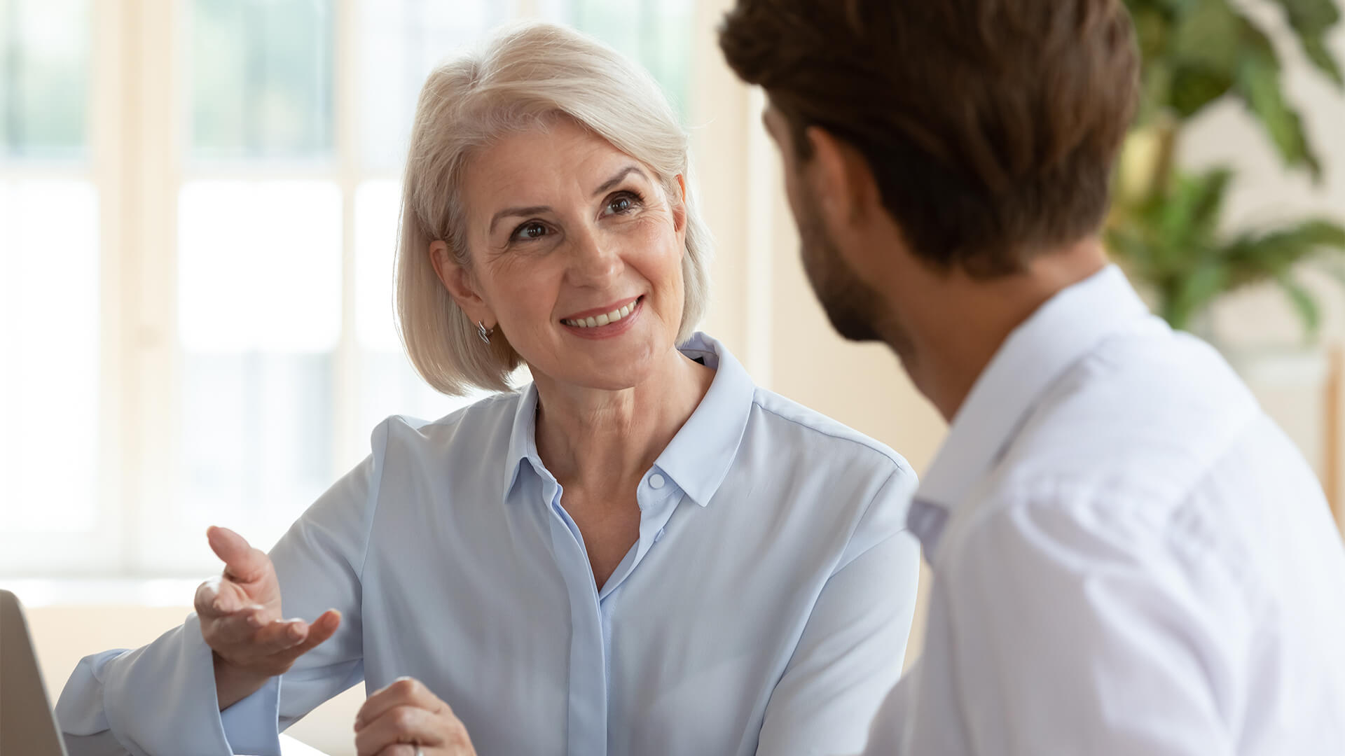 Interested in conversation aged businesswoman talk with colleague discuss new project startup plan