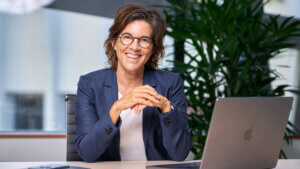 woman sitting at laptop smiling