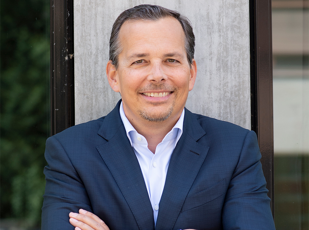 Man in blue suit smiling