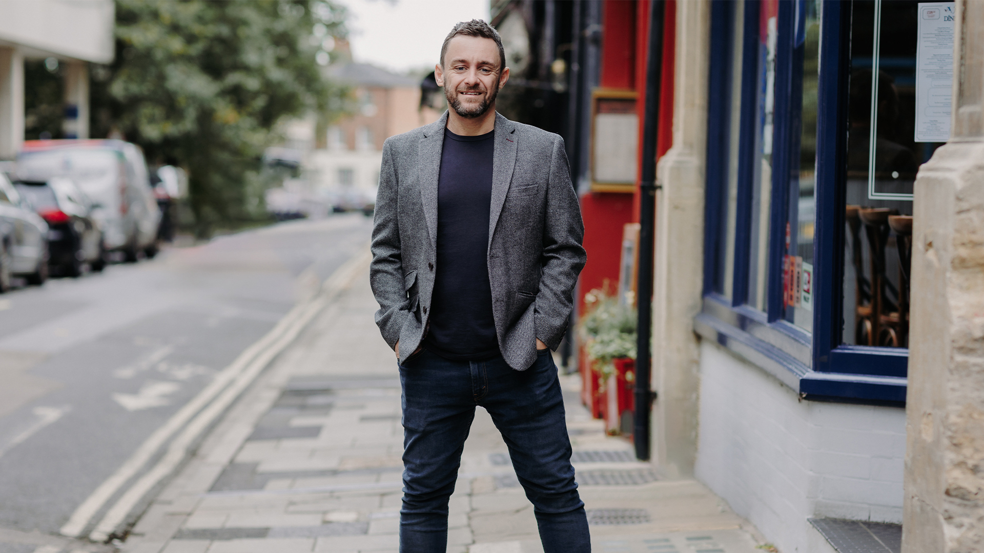 man standing on road smiling