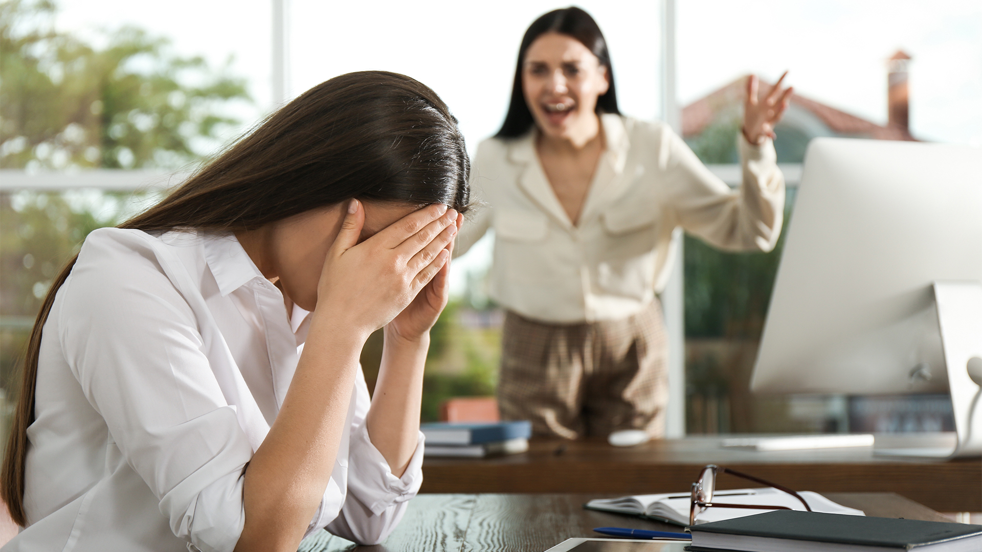 Boss screaming at employee in office