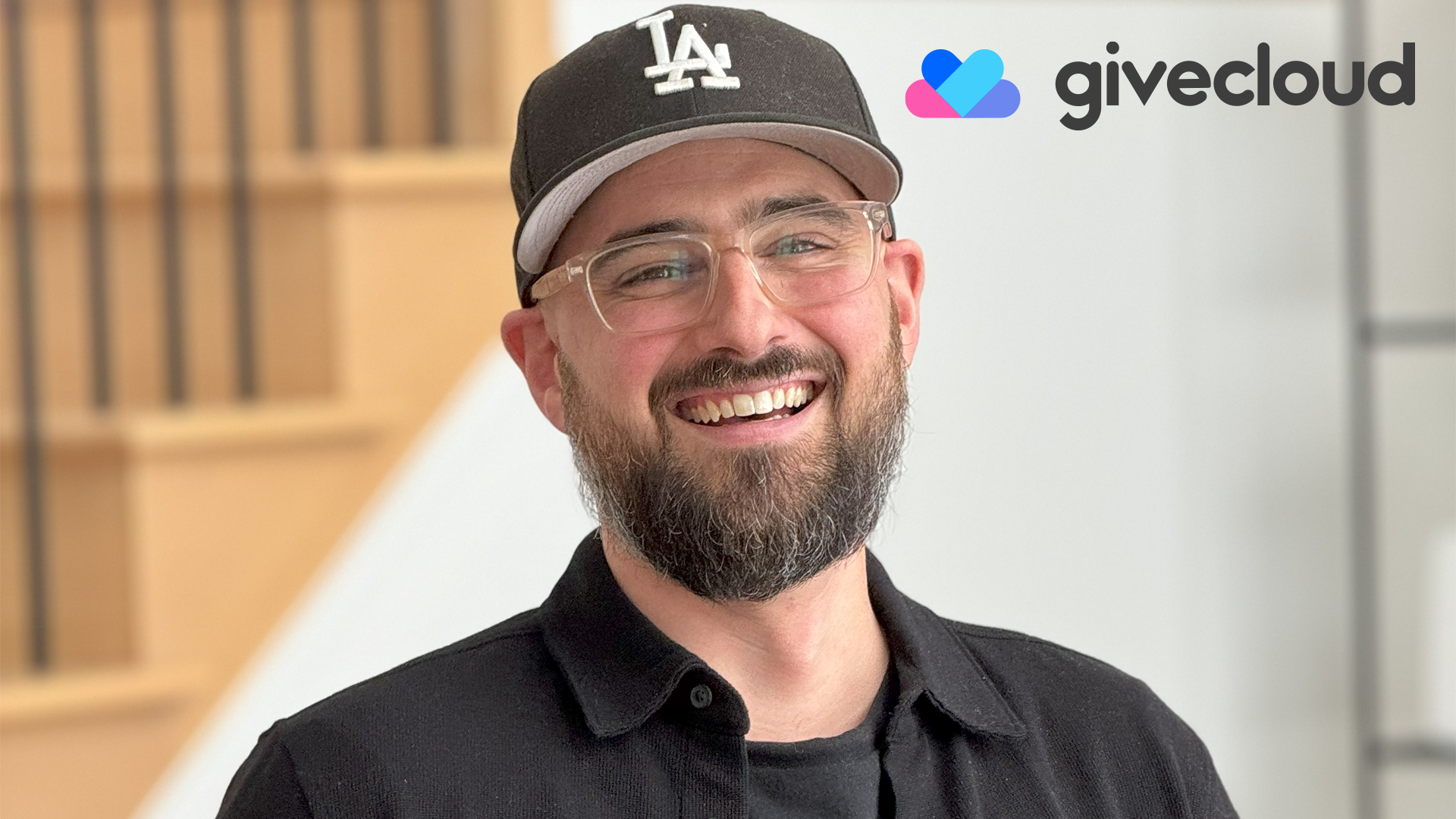 man in hat and glasses smiling