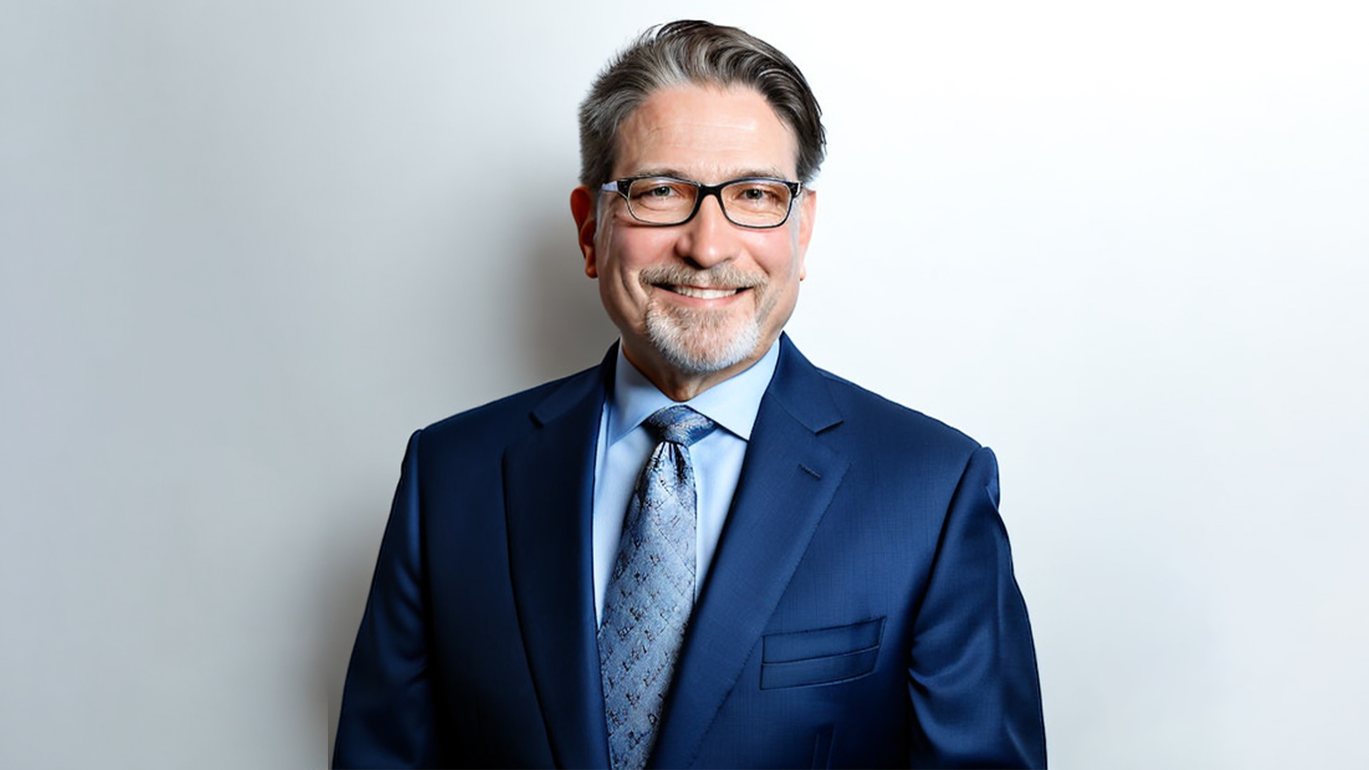 man in glasses and suit smiling