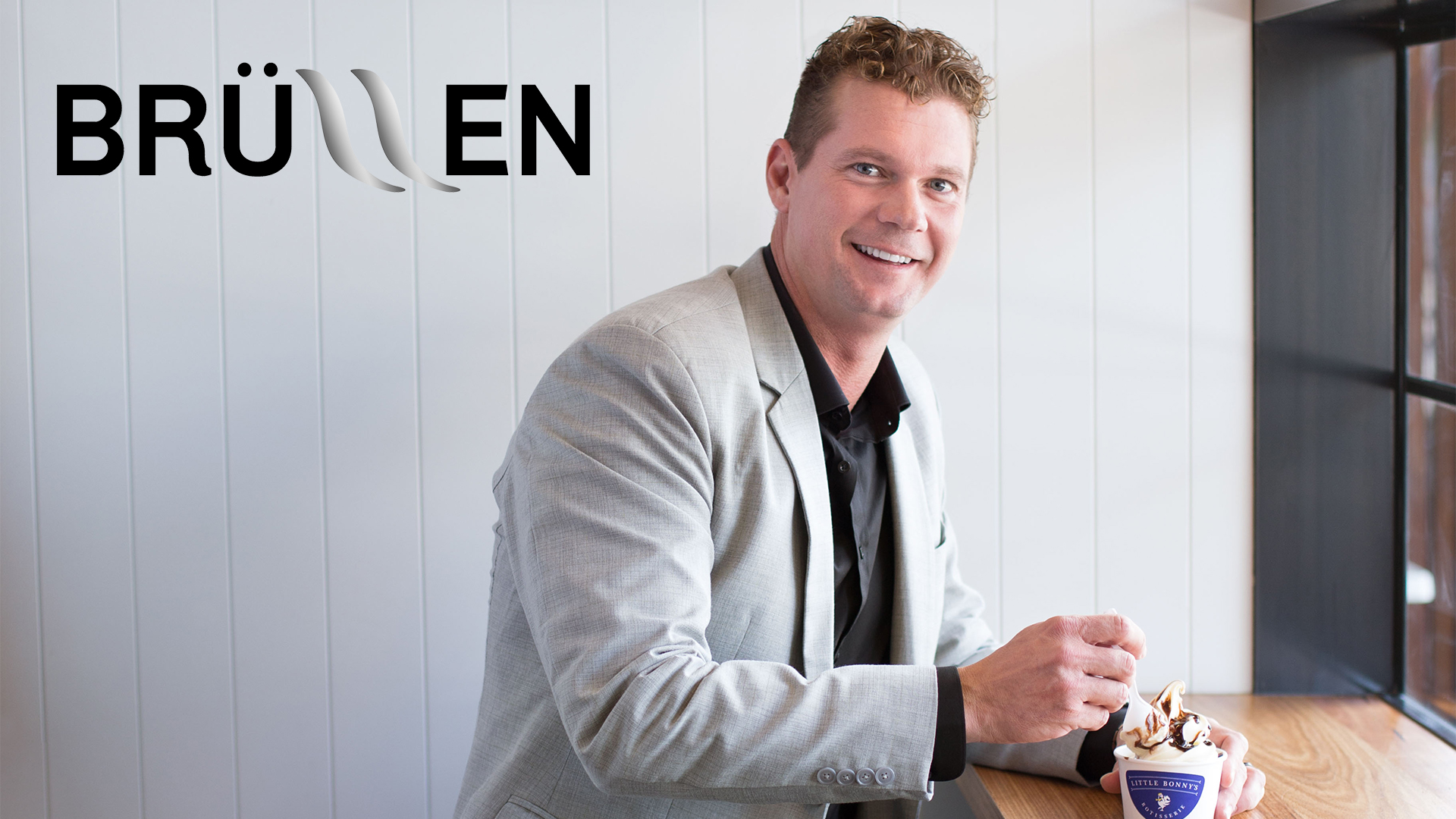 man with ice cream sitting down smiling