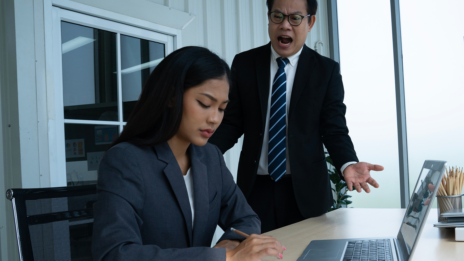 angry asian business man bully business woman