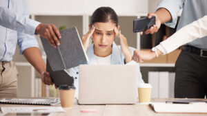 business woman with headache from workload and laptop deadline in office