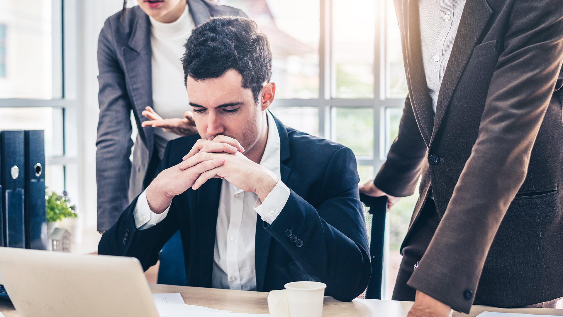 Businessman worry about his job with serious boss discussing while commenting a financial report document at meeting.