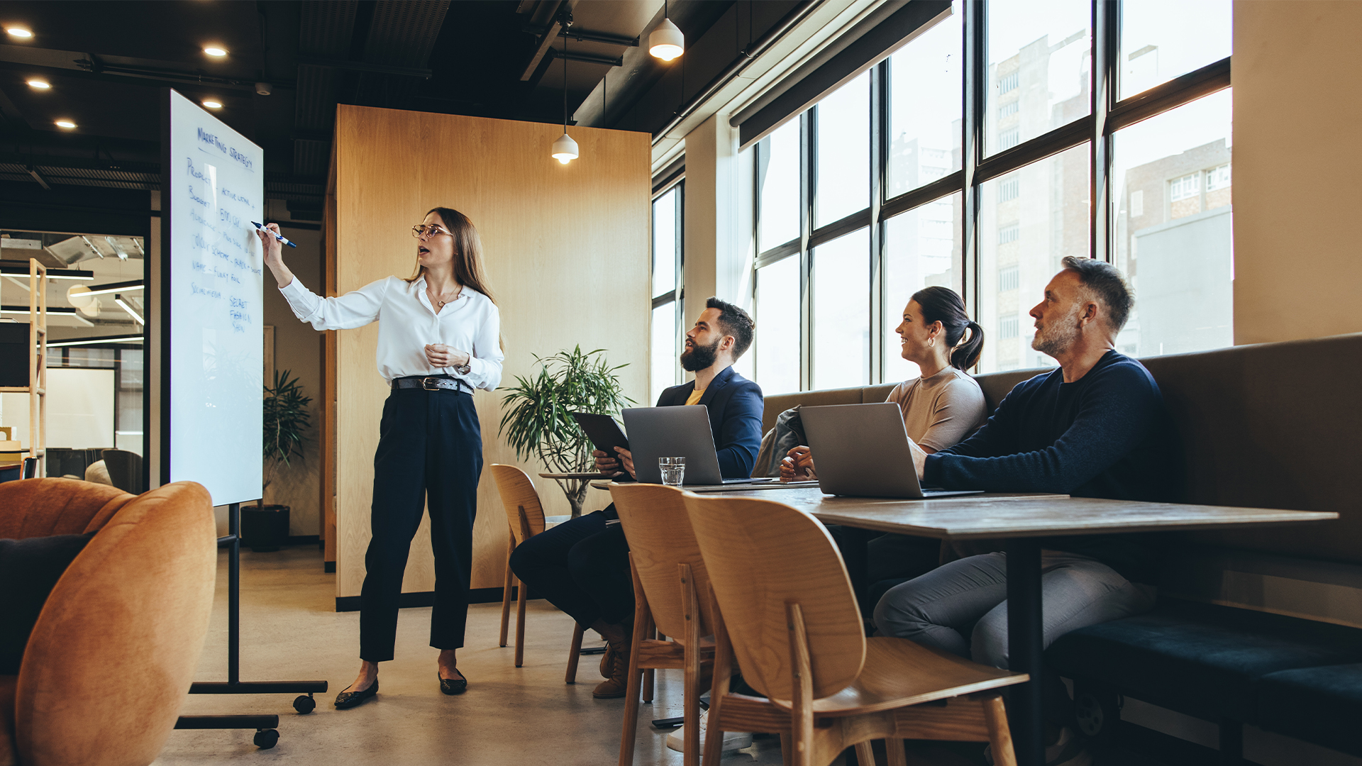 Female manager giving a presentation to her team